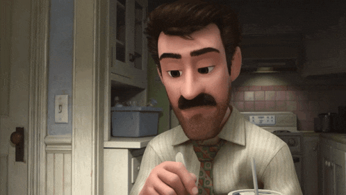 a man with a mustache is sitting in a kitchen eating something