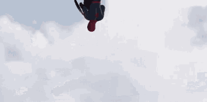 a man in a spider man suit holds a shield