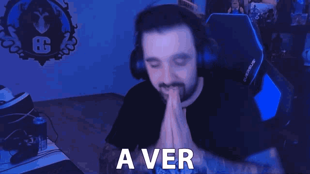 a man wearing headphones says a ver in front of a g logo