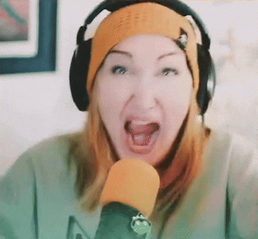 a woman wearing headphones and a beanie is talking into a microphone .