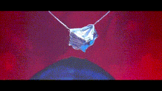 a piece of ice is hanging from a rope on a red background .