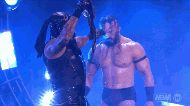 two wrestlers are standing next to each other with the aew logo on the bottom