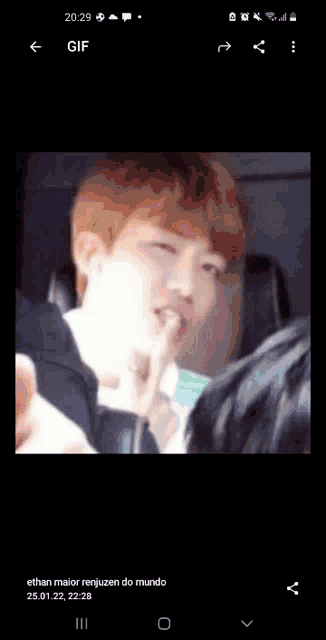 a phone screen shows a gif of a man licking his lips