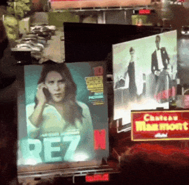 a screen displays a woman talking on a cell phone and the word rez on it