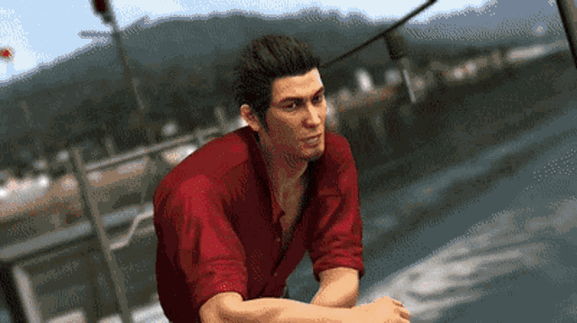 a man in a red shirt sitting on a boat