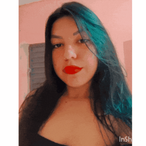 a woman with blue hair and red lipstick is taking a selfie with inshot
