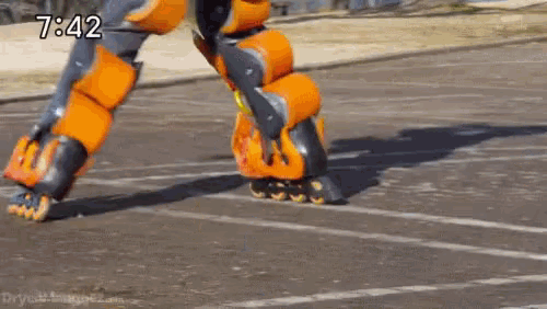 a robot is rollerblading on a road with the time 7:42 on the bottom