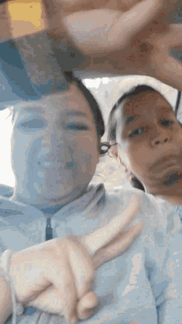 two women are sitting in a car making funny faces while holding hands .