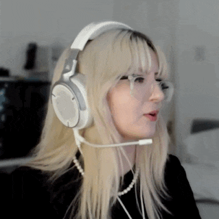 a blonde woman wearing headphones and a microphone .