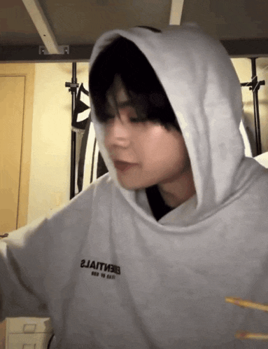 a person wearing a white hoodie that says 2jaitm3 on it
