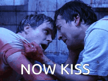 a couple of men standing next to each other with the words now kiss written on the bottom