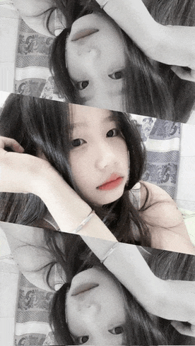 a girl with a bracelet on her wrist is laying on her back