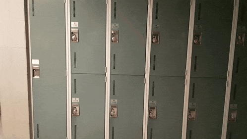 a row of lockers with numbers on the doors