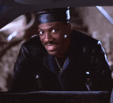 a man wearing a black hat and a leather jacket