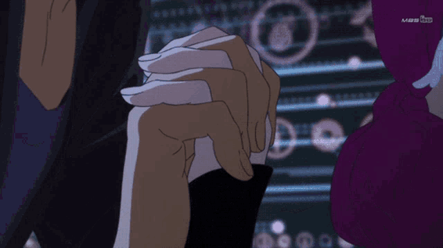 a person holding another person 's hand with mbs on the screen