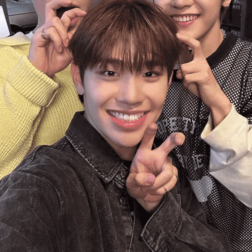 a man giving a peace sign with his fingers
