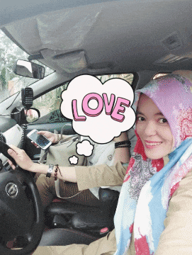 a woman sitting in a car with a thought bubble that says love