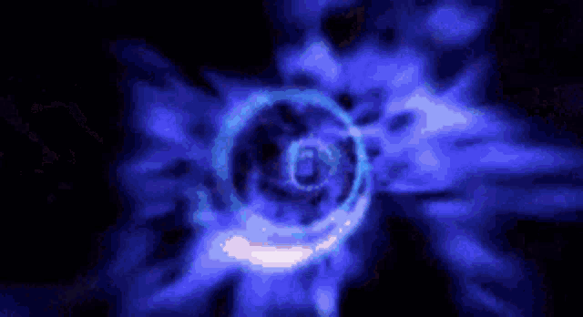 a blue swirl in the middle of a dark background .