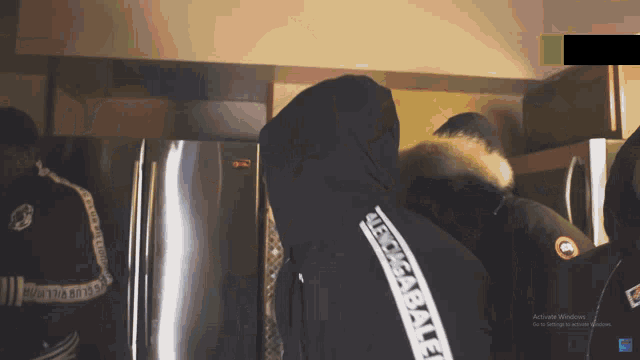 a person wearing a black jacket with the word abercrombie on the side