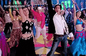 a group of people are dancing together on a dance floor in a club .