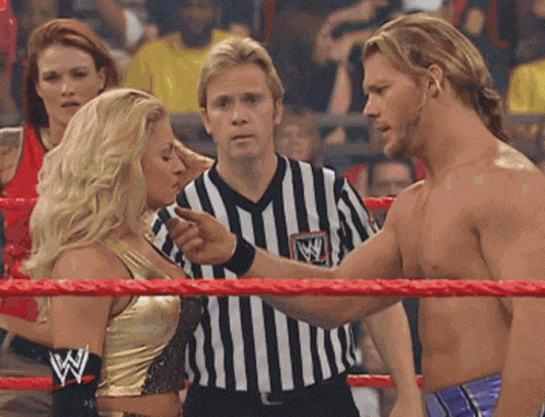 a man and a woman in a wrestling ring with a w on their sleeves