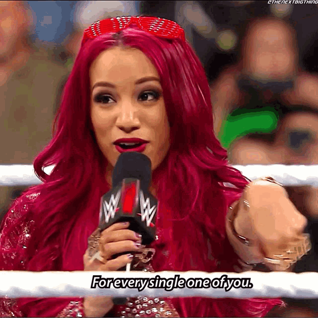 a woman with red hair speaking into a microphone with the words forever single one of you below her