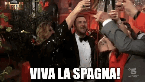 a group of people toasting with viva la spagna written on the screen