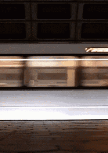 a blurry picture of a train going down the tracks with the word subway on the side