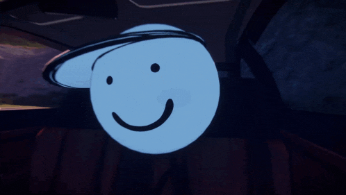 a blue smiley face with a hat on it is in the back seat of a car