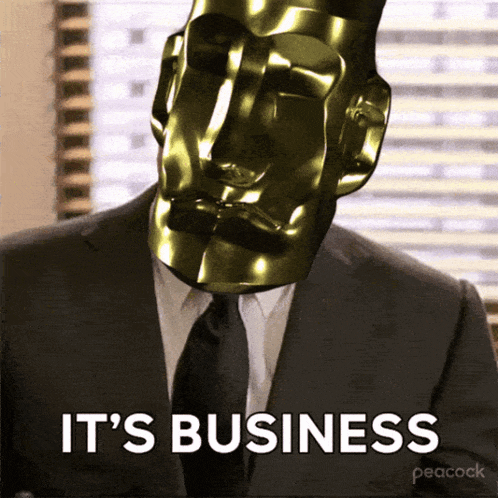 a man in a suit and tie has a gold mask on his head and the words it 's business below him