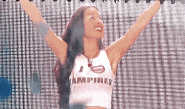 a woman wearing a white tank top that says vampires