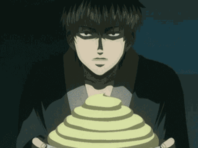 a man is holding a plate with a yellow pyramid on it