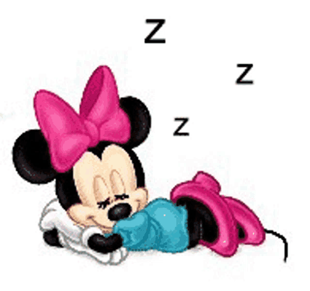 minnie mouse is sleeping on a blue blanket with a pink bow .