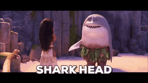 a shark head standing next to a woman in a white dress
