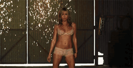 a woman in white lace shorts is standing in front of a mirror .