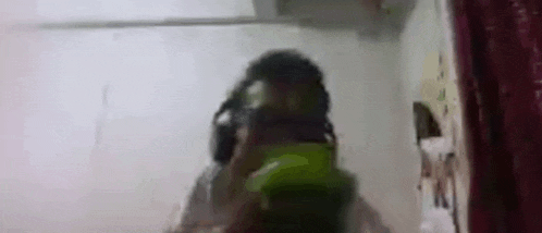 a blurry picture of a person wearing headphones .