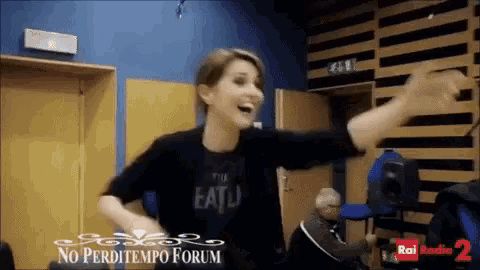 a woman wearing a black shirt that says eatu is dancing