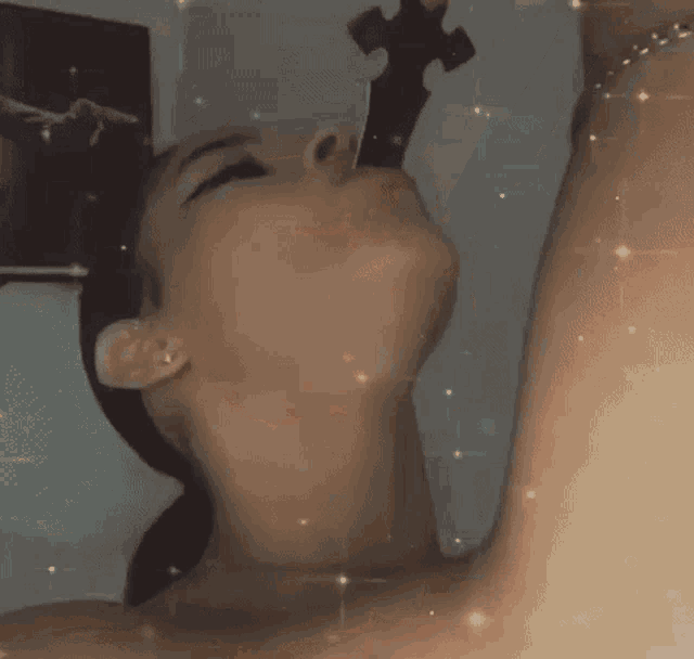 a close up of a woman 's face with a sword in her mouth