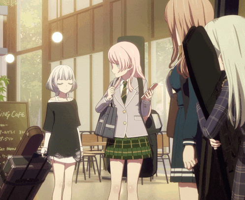 a group of girls standing in front of a sign that says ' king cafe '