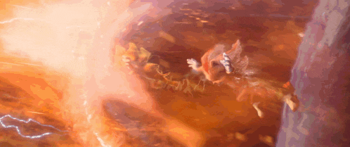 a squirrel is flying through the air in front of a fireball .