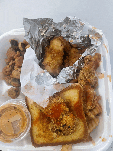 a plastic container with a lid that says solo sits next to a container of dipping sauce