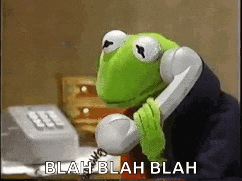 kermit the frog is talking on a telephone while sitting at a desk .
