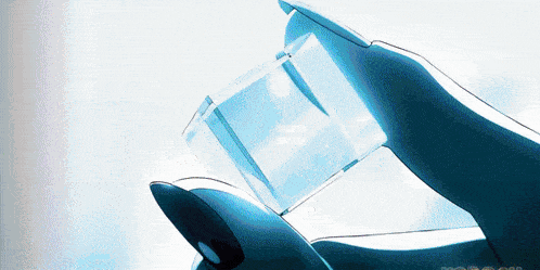 a person is holding a clear cube in their hand with the word ' optical ' on the bottom