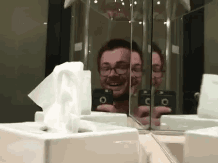 a man taking a picture of himself in the mirror