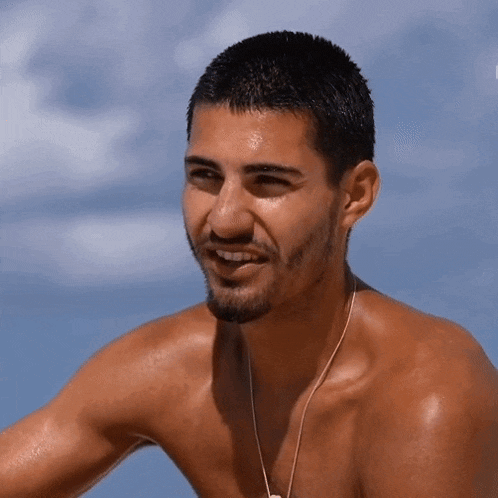 a shirtless man with a beard and a necklace around his neck
