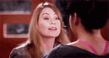 a woman in a pink bra is talking to another woman .