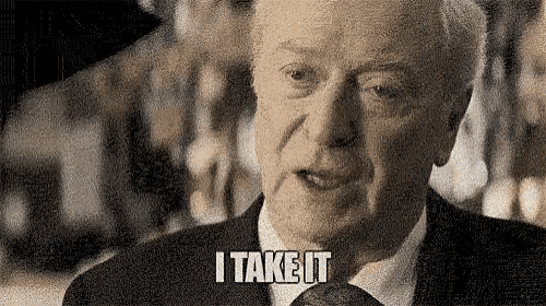 a man in a suit and tie is talking and saying `` i take it '' .