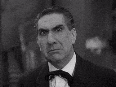 a black and white photo of a man in a suit