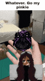 a person is holding a picture of a girl and a bug with the words whatever go my pinkie above it