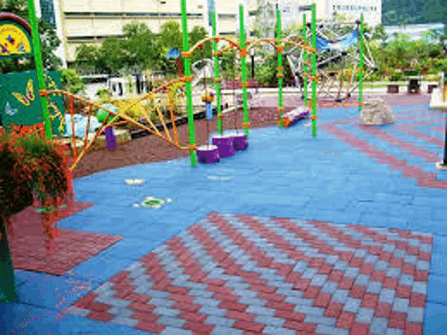 a colorful playground with blue and red tiles and a green butterfly sign